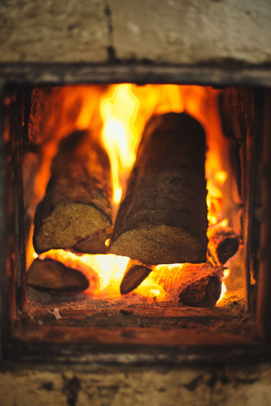 Logs burning cleanly inside a well-swept wood burner